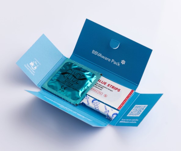 A small blue package with the label 'BBV Aware Pack'. Inside is a condom, stick of chewing gum and a band aid.